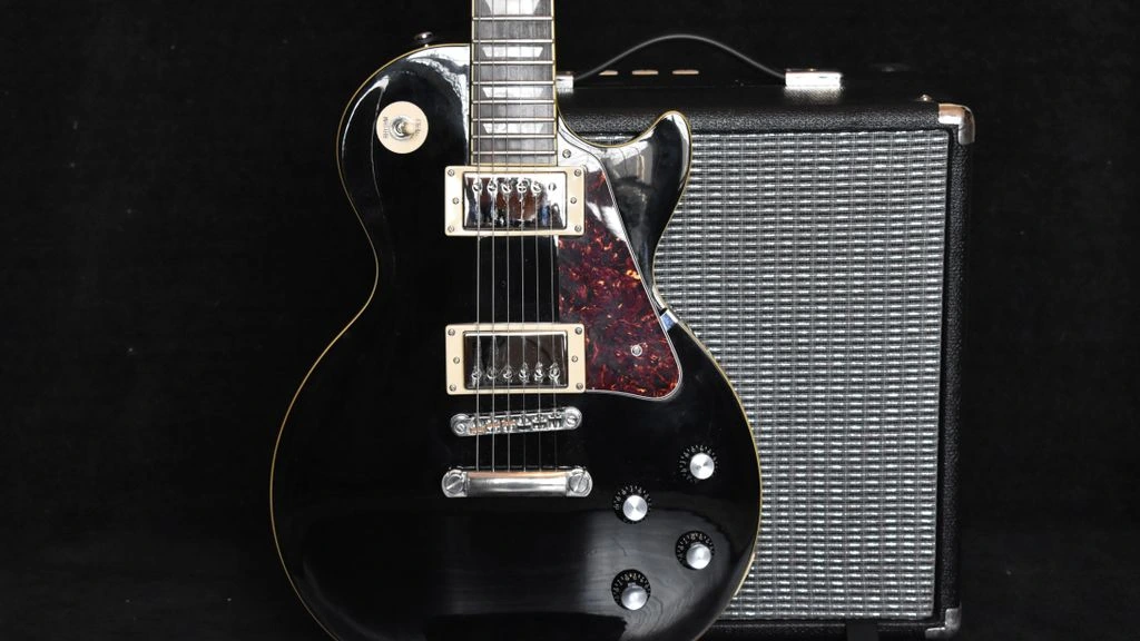 A vintage Greco electric guitar photographed in natural light on warm linen.