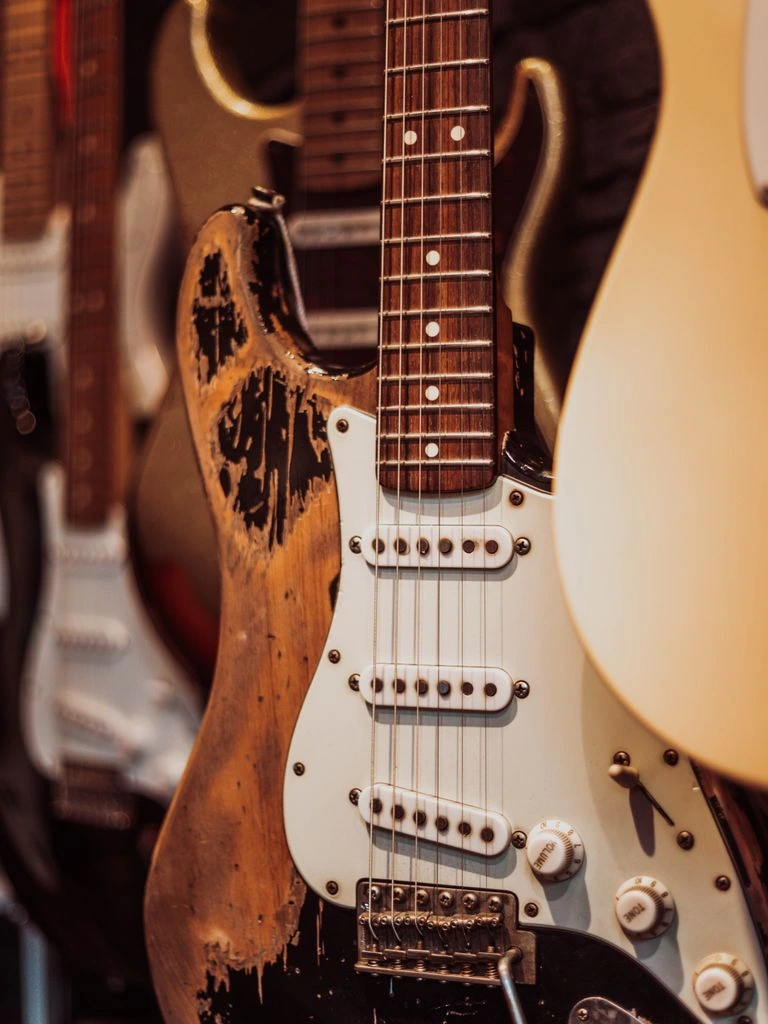 A 1977 Greco EG-800 electric guitar photographed on warm linen.