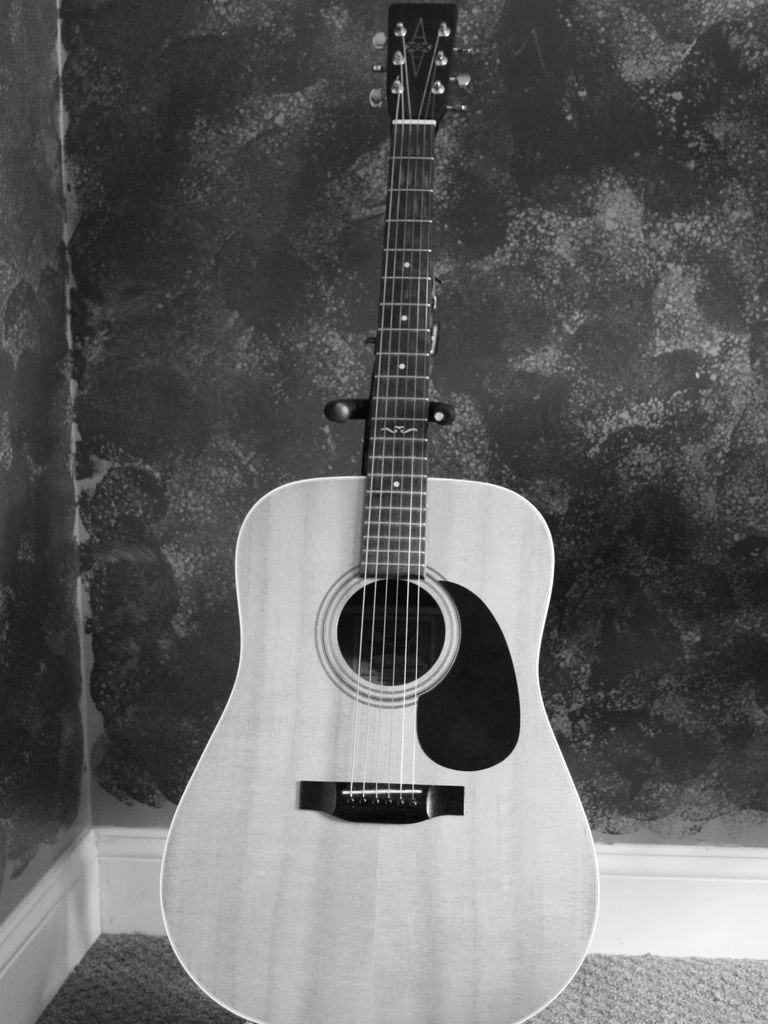 A 1968 Yamaha FG-180 acoustic dreadnought guitar.
