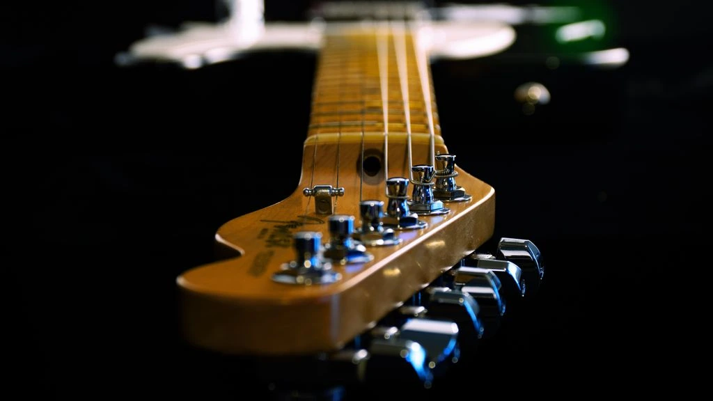 A 1974 Greco EG-600 electric guitar resting on a felt-lined workbench under warm tungsten light